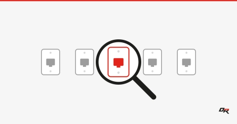 Five gray wall-jack faceplates in a row on an off-white background, with a black magnifying glass held over the center plate, which shows red inside the lens.