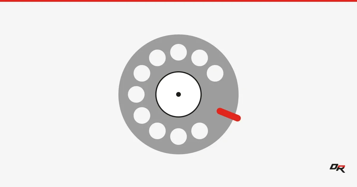 A gray rotary telephone dial with ten finger holes on a light gray background, with a red finger stop at the edge of the dial.