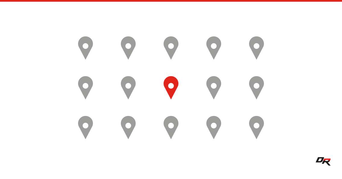 A grid of fifteen gray map pins with the single centre pin picked out in red, on a white background.
